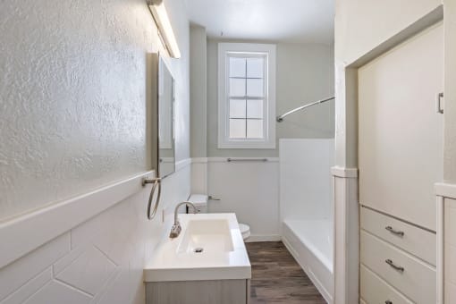 an empty bathroom with a sink and a shower