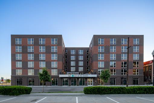 A large building with a parking lot in front of it.