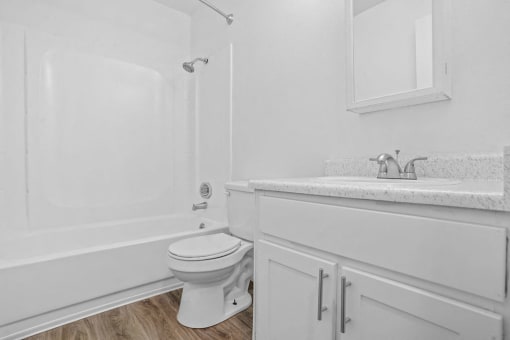 a bathroom with a sink toilet and a bath tub