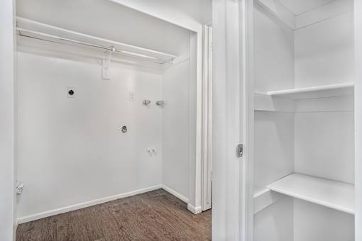 A white room with a doorway leading to another room.