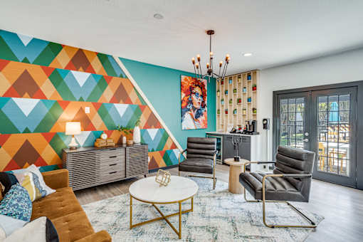 Resident clubhouse with colorful lounge seating at The Melville Apartments in Lake Highlands