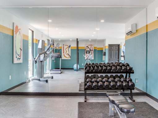 Fully equipped resident fitness center at The Melville Apartments in Dallas