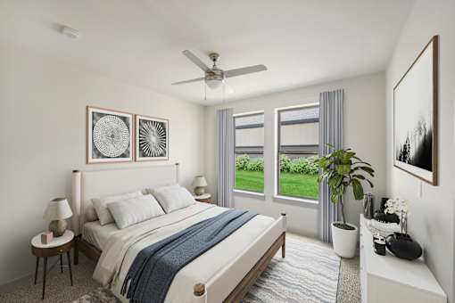 Bright bedroom with ceiling fan and garden view at The Westerly Apartments, Midlothian, TX