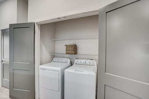 Inunit laundry room with washer and dryer at The Mill Old Town Apartments, Lewisville, TX