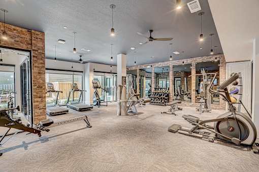 Fitness center with cardio and strength equipment at The Mill Old Town Apartments, Lewisville, 75057