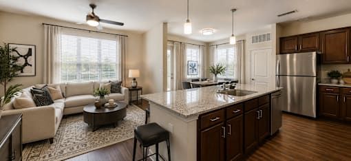 Spacious kitchen with a center island, bar seating, and stainless steel appliances at Auberge of Tyler.