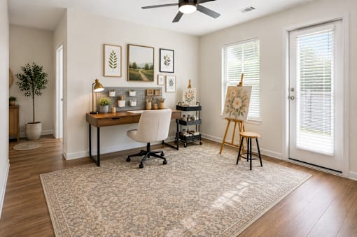 Bright flex room staged as a home office and creative workspace at Auberge of Tyler.
