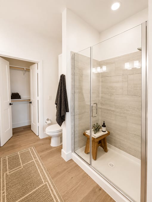 Spacious  bathroom featuring walk-in shower and modern finishes.