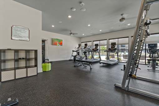 A gym with a variety of equipment including weights and machines.