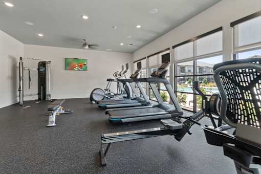 A gym with treadmills and elliptical machines.