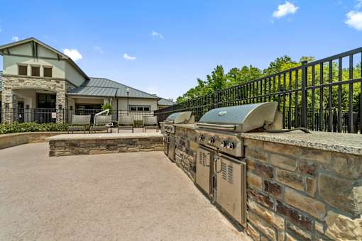 Outdoor grilling station with stone surround at Auberge of Tyler apartments in Tyler TX.