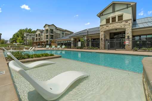 Pool area at Auberge of Tyler apartments in Tyler TX with sun deck.