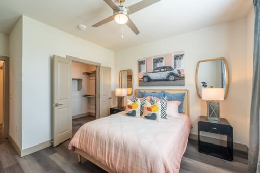 a bedroom with a bed and a ceiling fan at One Preston Station, Celina, Texas