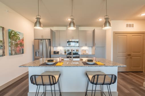 a kitchen with an island and three stools