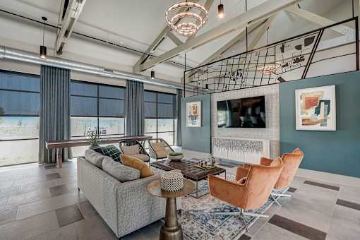 Stylish resident clubroom with lounge seating at One Preston Station Apartments.