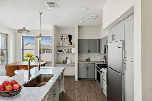 Modern kitchen with island and stainless appliances at The Westerly Apartments, Midlothian