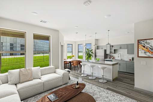 Open concept living room and kitchen with island seating at The Westerly Apartments, Texas