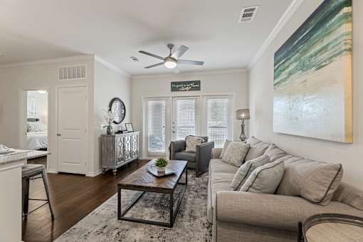 Living room interior at Auberge of Burleson apartments in Burleson TX featuring modern décor.