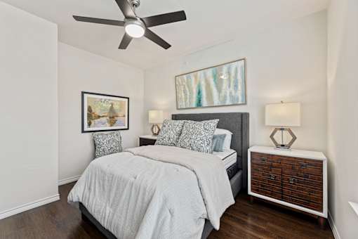 Spacious bedroom with ceiling fan at Auberge of Burleson apartments in Burleson TX.