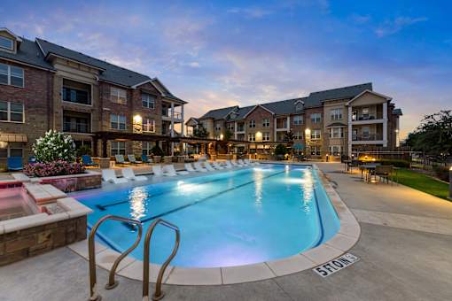 A large swimming pool in front of a building with the name "BROOK" written on the ground.
