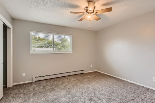 A bedroom with a window and floor heater at Alder Square Townhomes Apartments