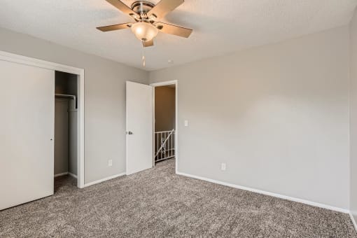 A bedroom with a closet at Alder Square Townhomes Apartments