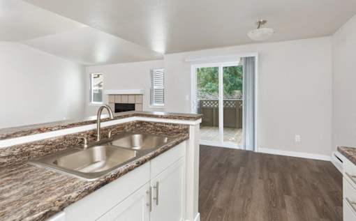 A kitchen with a sink and a counter top.