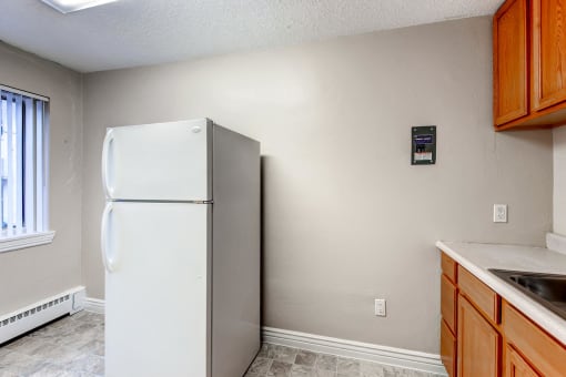 Kitchen with white appliances at Fountainhead Apartments, Denver, Colorado