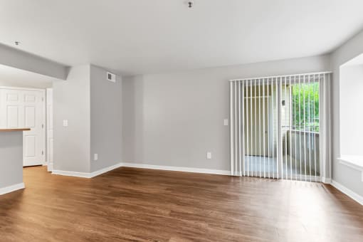 A Living Room with a view of the Patio/Balcony at The Buttes Apartments, Loveland Colorado