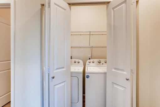 A small laundry room with a washer and dryer.