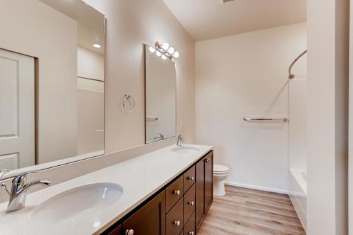 A bathroom with a white countertop and a white sink.