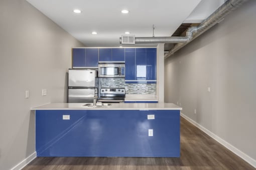 Our Apartment Kitchen with Blue Cabinets at Sleek Lofts