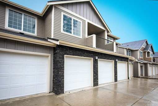 A row of houses with attached garages.