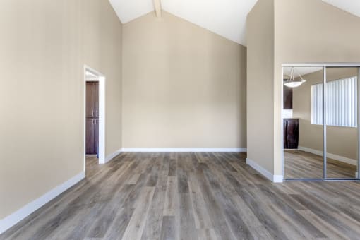 Welcome to Independence Plaza: Where chic meets space. Discover updated flooring, mirrored storage, and endless possibilities in this inviting living room.