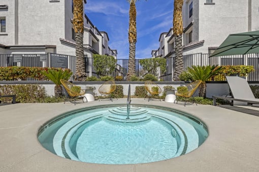 The Michael B's luxury apartment complex boasts a tranquil jacuzzi retreat, surrounded by lush palm trees and sleek architectural marvels. Dive into serenity amidst the cityscape.at The Michael B Town