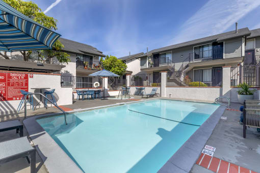Dive into luxury living at Independence Plaza, where every day feels like a vacation with our refreshing swimming pool and stylish patio retreat adorned with cozy umbrellas.