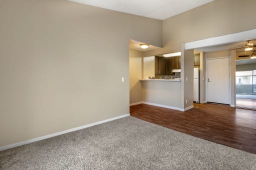 a bedroom with hardwood flooring and a doorway into a kitchen