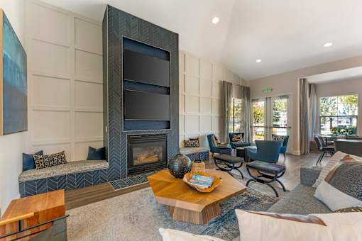The clubhouse features dual TVs and a cozy fireplace, creating a warm and inviting space for residents to relax and socialize at Ascent at the Galleria.