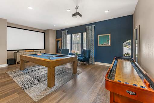 The rec room in the clubhouse is perfect for hanging out, featuring a pool table, TV, and shuffleboard for fun and relaxation at Ascent at the Galleria.