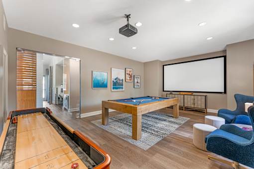 The clubhouse offers a variety of amenities, including a rec room with a pool table, TV, and shuffleboard—perfect for relaxing and socializing at Ascent at the Galleria.
