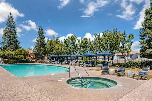 Unwind on our tree-lined pool deck with lounge chairs, a large sparkling pool, and a relaxing jacuzzi—just steps from the clubhouse and leasing office at Ascent at the Galleria.
