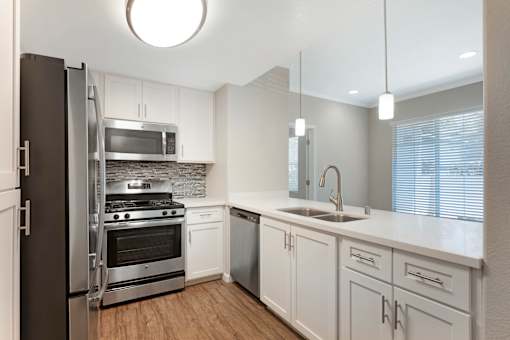 Our renovated kitchens open to the living room, creating a spacious flow—perfect for hosting guests and enjoying seamless entertaining at Ascent at the Galleria.
