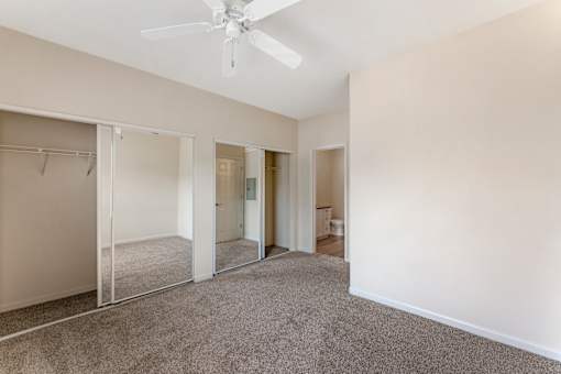Bedrooms at Ascent at the Galleria come with cozy carpeting and ceiling fans, providing comfort and a relaxing atmosphere in every home.