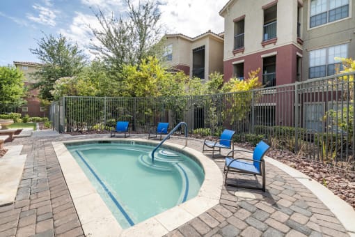 Soothing Spa With Beautiful Landscaping and Four Blue Lounge Chairs. at Sonata Apartment Homes, Las Vegas, Nevada