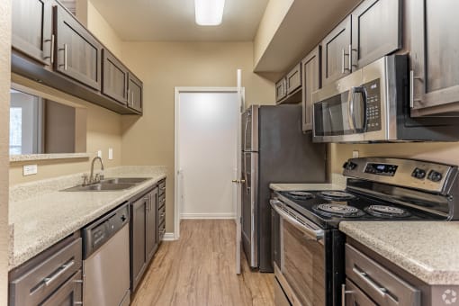 This unit boasts a spacious, freshly renovated kitchen complete with sleek stainless steel appliances.at The Hills at Quail Run in Riverside, California