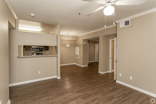 This unit features beautiful hardwood floors, a modern ceiling fan, and fresh paint throughout for a stylish and comfortable living space.at The Hills at Quail Run in Riverside, California