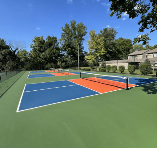 a tennis court with four different courts on it on a sunny day