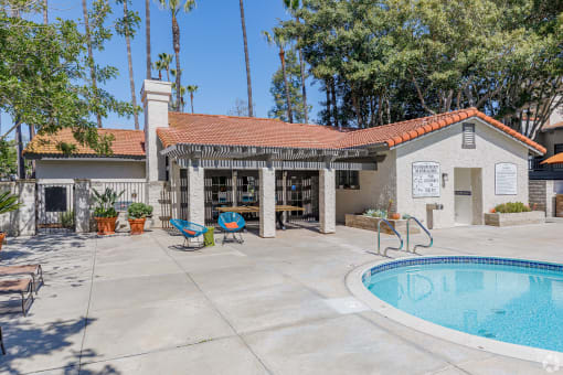 Clubhouse with a pool and patio at La Serena, San Diego, 92128