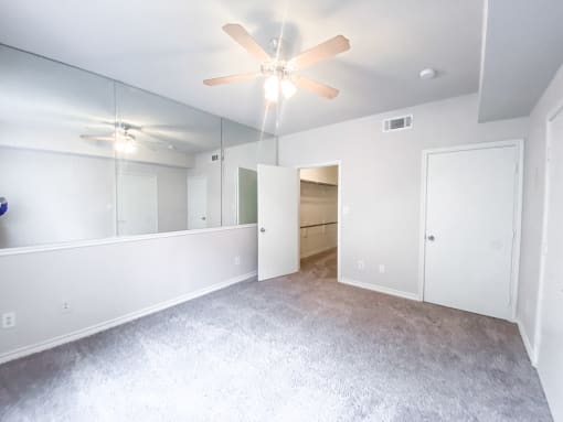 Spacious bedroom with walk in closet at Tuscany Square Apartments in North Dallas, TX. Now leasing studios, 1 and 2 bedroom apartments.