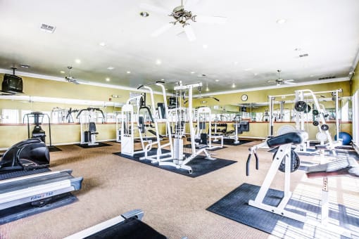High energy fitness center fully equipped with fitness equipment in the Trinity Square Apartment Homes in North Dallas, TX!